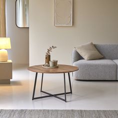 a living room scene with focus on the coffee table and sofa in the foreground