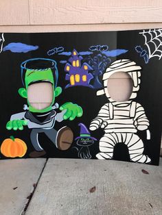 two cardboard cutouts of children's halloween costumes