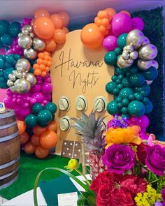 there is a sign that says hawaii nights with balloons and flowers in front of it