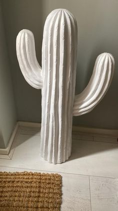 a large white cactus sitting on top of a rug