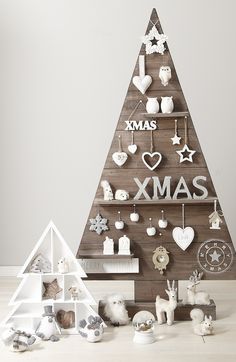 a wooden christmas tree with ornaments on it and the words xmas not a creature was stirring