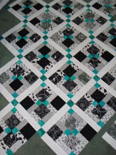 a black and white quilt on the floor