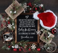 a christmas wreath with santa hat and other holiday decorations on the table next to it is a sign that says, you better watch out you've been not yet