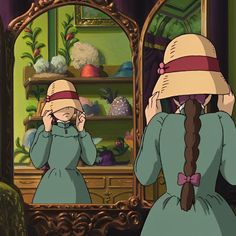 two women in dresses and hats look at their reflection in a mirror while wearing matching hats