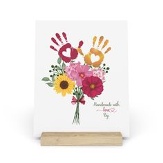 a card with flowers and hand prints on it