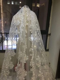 a wedding veil with white flowers on it