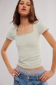 A new addition to your favorite seamless collection, this ultra-soft tee is featured in a slim-fitting silhouette with a square neckline and cap-inspired sleeves. **Fit:** Slimmer silhouette, hip-length **Features:** Buttery soft fabrication with a stretchy feel, seamless design, square neckline, cap-inspired sleeves, lining at bust **Why We | Clean Lines Sunfade Baby Tee by Intimately at Free People in Blue, Size: XS/S Barista Outfits, Shoes Jeans, Design Square, Black Fits, Baby Tee, Cute Tops, Square Neckline, Tee Shop, Infant Tees