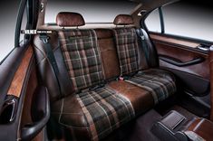 the interior of a car with brown and black plaid upholstered seat covers on it