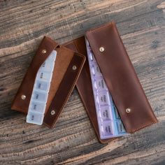 Elevate your daily routine with our Handcrafted Leather Pill Case, a personalized and stylish solution for organizing medications. This 7-day tablet holder comes with a convenient plastic pill box neatly enclosed in a genuine leather case. Thoughtfully designed for both functionality and aesthetics, it makes an ideal Grandparents' gift or a special treat for yourself. Stay organized in style with this unique, handcrafted medication storage solution. PRODUCT FEATURES: ❖ Leather Case is available Functional Rectangular Wallet For Gift, Portable Rectangular Case Organizer As A Gift, Rectangular Organizers With Pen Slots As Gift, Rectangular Organizer With Pen Slots For Gift, Rectangular Organizer With Pen Slots As Gift, Rectangular Pen Holder Organizer As Gift, Organizing Medications, Medication Organizer, Medication Organization