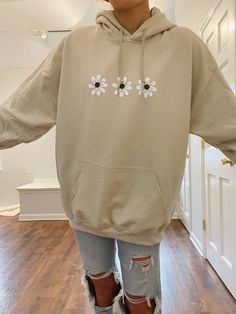 "Sand/tan colored hoodie with 3 black & white daisy flowers. This hoodie is seriously the cutest and so cozy. ✰ MODEL INFO: ✰ Height: 5'4\" Size: normally wears a small, but is modeling a large for an oversized look. ★ MATERIAL: ★ 50% cotton, 50% polyester" Hoodies For Teenagers Girl, Granola Girl Outfits, Hoodies For Girls, Floral Sweatshirt, Hoodie Aesthetic, Womens Hoodies, Gildan Hoodie, Daisy Flowers, White Daisy