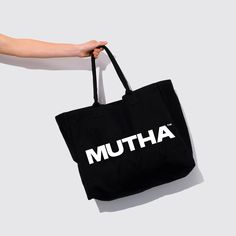 For MUTHAs on the go, our oversized tote carries all of life’s necessities. Designed with durable organic cotton and an easy-on-the-shoulder handle— it’s the perfect sustainable option for shopping at the market, working on the go and your next weekend getaway. 100% organic cotton. 100% iconic. Cotton Weekender Bag For Everyday Summer Use, Summer Cotton Weekender Bag For Everyday, Summer Cotton Bag For On-the-go, Large Capacity Cotton Weekender Bag For Daily Use, Large Capacity Cotton Weekender Bag, Rectangular Cotton Weekender Bag For On-the-go, Rectangular Cotton Weekender Bag, Branded Tote Canvas Bag For Everyday, Branded Everyday Tote Canvas Bag