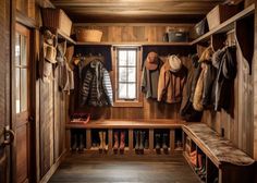 a wooden closet with several coats and boots