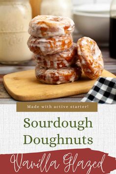 some glazed doughnuts sitting on top of a cutting board next to a jar of milk