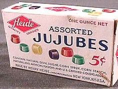 an unopened jujubes box sitting on top of the floor in front of a wall