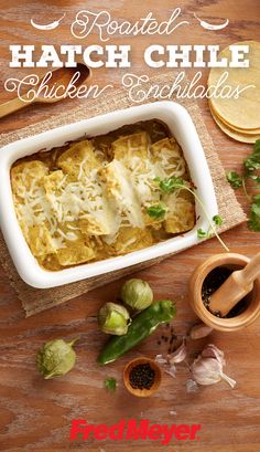 a casserole dish with chicken and cheese in it on a wooden table next to tortillas