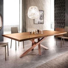 a modern dining table with two chairs and a light fixture hanging from it's ceiling