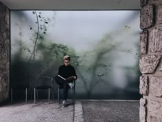 a man sitting in a chair reading a book