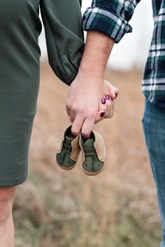 two people holding hands while standing next to each other