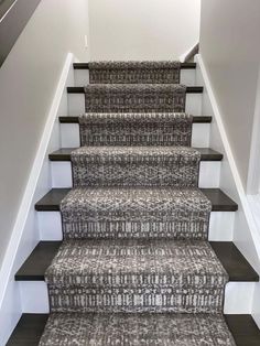 a carpeted staircase leading up to the second floor