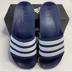 New In Box Adidas Adilette Shower Slides In Navy Blue/ Cloud White. Size 6. Details: Slip On And Go. These Slides Mix 3-Stripes Style With A Comfortable Cloudfoam Unitsole, Which Combines The Midsole With The Outsole For Superior Cushioning. Finished With A Bold Linear Logo On The Side. Blue Adidas Synthetic Slides, Adidas Blue Synthetic Slides, Adidas Blue Slip-on Slides, Adidas Blue Slides For Beach, Blue Adidas Slides For Beach, Blue Adidas Slides For The Beach, Mens Slides Sandals, Adidas Slippers, Adidas Sandals