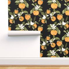 an orange wallpaper with white flowers and leaves on black background next to a door