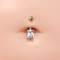 A unique gem shape makes all the difference when it comes to body jewelry, and that's exactly why this alluring belly button right deserves your attention. With its polished 14k gold finish, and the unique emerald cut cubic zirconia, you get the bling you crave in a distinctive, sophisticated cut. Choose from yellow, white or rose gold and two different barbell lengths. AAA grade cubic zirconia Gemstone: 8x6mm emerald-cut Basket setting Nickel-free, solid 14k gold Barbell size: 14G Internally th Elegant 14k Gold Belly Rings For Gift, Elegant 14k Yellow Gold Belly Rings, Gem Shapes, Gold Belly Button Rings, Eyebrow Jewelry, Ear Lobe Piercings, Diamond Nose Ring, Nose Bones, Nose Piercing Jewelry