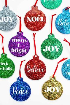 christmas ornament ornaments with the words noel, merry and joy in different colors