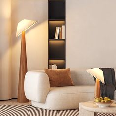 a living room filled with furniture and a lamp on top of a wooden table in front of a book shelf