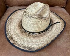 This Jason Aldean Resistol cowboy hat is a must-have for any western enthusiast. Made with natural materials and featuring a verde bound palm leaf and cattleman crease, this hat is both stylish and functional. Perfect for unisex adults, this hat is available in size 7 and is sure to be a hit at any Jason Aldean concert. The hat is perfect for those who love the western theme and want to show it off in style. Jason Aldean Concert, Jason Aldean, Western Theme, Palm Leaf, Cowboy Hat, Hat Sizes, Natural Materials, Cowboy Hats, In Style