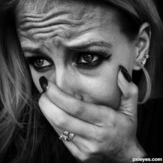 black and white photograph of a woman with her hands on her face, covering her mouth