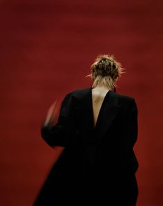 the back of a woman in a black suit