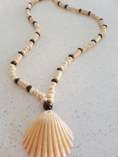 Beautiful handmade necklace with shell and wooden beads. It is nice piece of jewellry. It is a perfect gift for any occasions. Brown Shell Necklace As A Gift, Handmade Shell Necklaces, Adjustable Shell Necklace With Wooden Beads As Gift, Beaded Brown Shell Necklace As Gift, Brown Beaded Shell Necklace For Gifts, Bohemian Jewelry With Wooden Beads And Shell, Shell Necklace With Wooden Beads For Beach, Wooden Beads Shell Necklace For Beach, Brown Shell Necklace With Round Beads For Gift