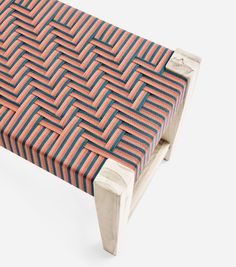 an upholstered bench with red and blue stripes