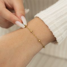 The Dotted Twisted Bracelet features a spiraling chain that brings gorgeous dotted beads together for the perfect touch that exudes confidence, whether you're going for a day out or a night in. Materials & Warranty Length: 6" with a built-in 2" extension for a total of 8 inches Real 18 Karat Gold Plating over Pure Stainless Steel Hypoallergenic | Sensitive Skin-Friendly Warranty: Lifetime Warranty against all rust or tarnish Waterproof & Sweatproof | Keep them on in the shower Packaging: Nominal Twisted Bracelet, Night In, Silver Bracelets, Gold Plating, Sensitive Skin, Rust, Built In, Gold Plate, Dots