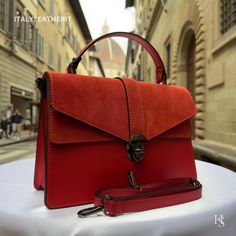 This bag has been made of the best genuine leather by local master crafters of Florence in Italy, designed for women who only accept premium Italian quality and luxury leather bags and modern Italian fashion. . Sizes: Width: 29cm/10.6 inch Height: 19cm/7.4 inch Depth: 7 cm/3.9 inch color: Red . The story of this bag: Once upon a time, in the heart of Florence, there was a small workshop where skilled artisans crafted elegant leather bags for women. The workshop was famous for its red leather bag Luxury Handmade Red Bags, Leather Flap Bag With Smooth Grain For Daily Use, Daily Use Leather Flap Bag With Smooth Grain, Classic Red Satchel With Leather Handles, Red Luxury Satchel With Leather Handles, Luxury Red Satchel With Leather Handles, Red Leather Travel Briefcase, Luxury Leather Flap Bag As Gift, Luxury Leather Flap Bag Gift