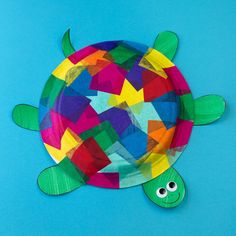 a paper plate with a turtle made out of different colored papers and eyes on it