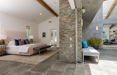 Chic hotel style indoor outdoor luxury bedroom in custom LA home, with sliding glass walls that open up the room to the attached terrace & stacked slate wall. Tile Floor Bedroom, Floor Bedroom Design, Tiles Floor Bedroom, Modern Master Suite, Stacked Stone Wall