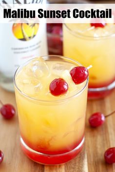 two glasses filled with alcoholic drinks on top of a wooden table