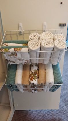 towels are stacked on top of each other in a rack