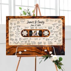 a wooden sign with two pictures on it and the names of guests written in black ink