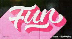 a pink and white sign on the side of a building that says fuc in cursive writing