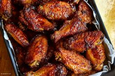 chicken wings in tin foil sitting on top of a table