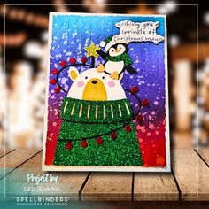 a christmas card with an image of a penguin in a green sweater on top of a tree