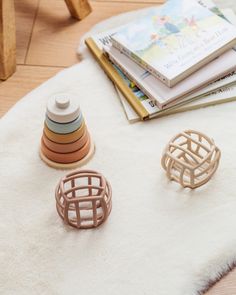 three rings sitting on top of a white rug next to stacks of books and magazines