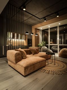 a living room filled with lots of furniture next to a tall glass wall in front of a window