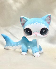 a blue and white cat figurine with big eyes