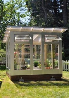 a small garden shed in the middle of a yard