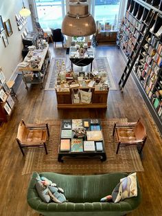 a living room filled with furniture and lots of books