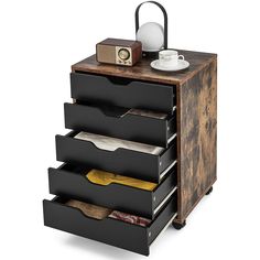 a wooden drawer with five drawers and a tea kettle on top