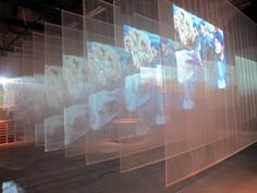 an art installation with multiple images projected on the wall